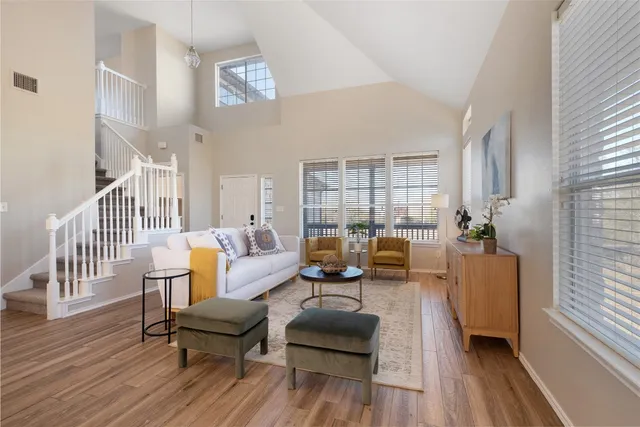a living room with furniture and wooden floor