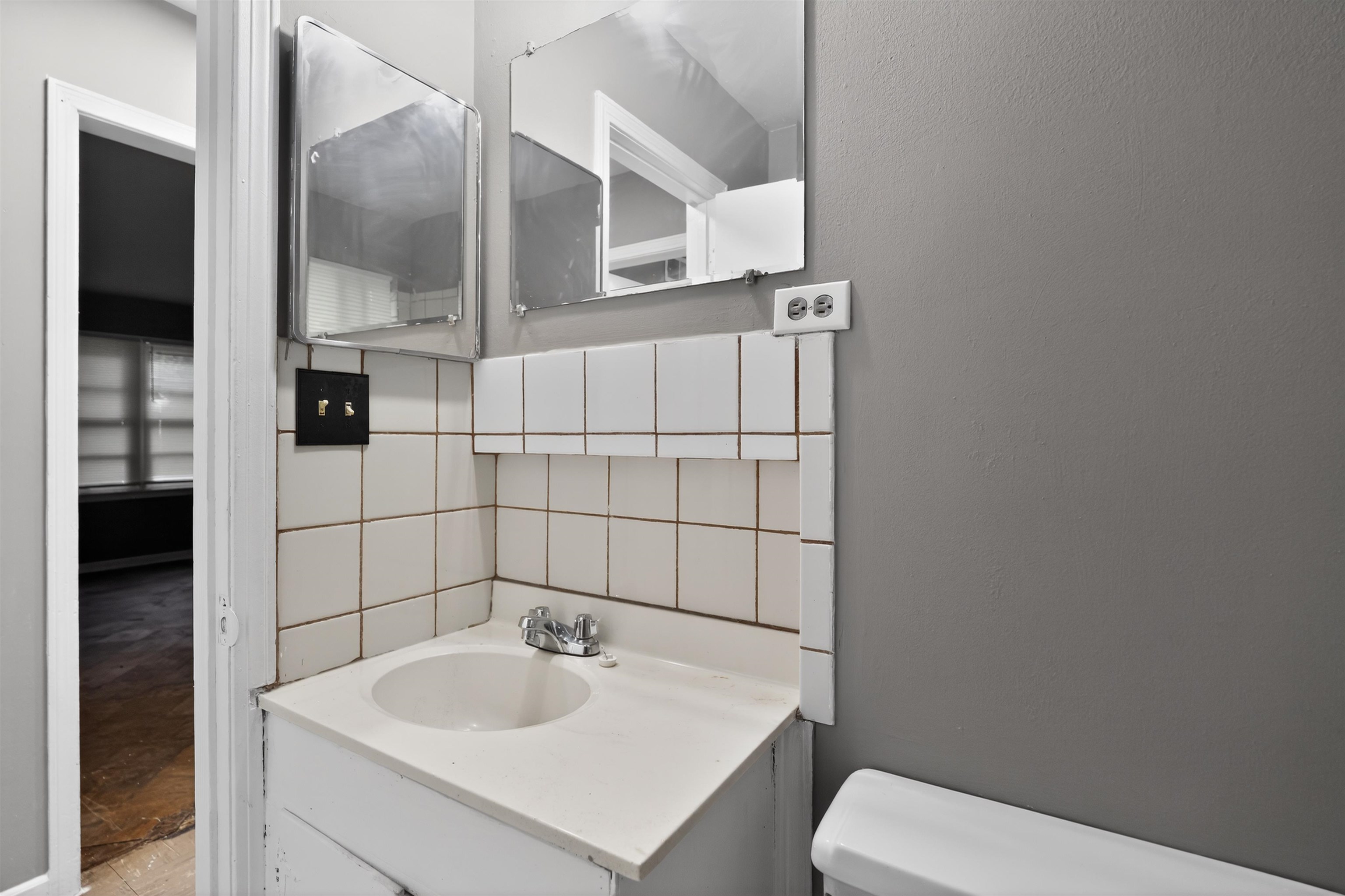 1422 Abernathy Road Memphis, TN 38116 - Photo 26 of 30 White tile backsplash and vanity with integrated sink