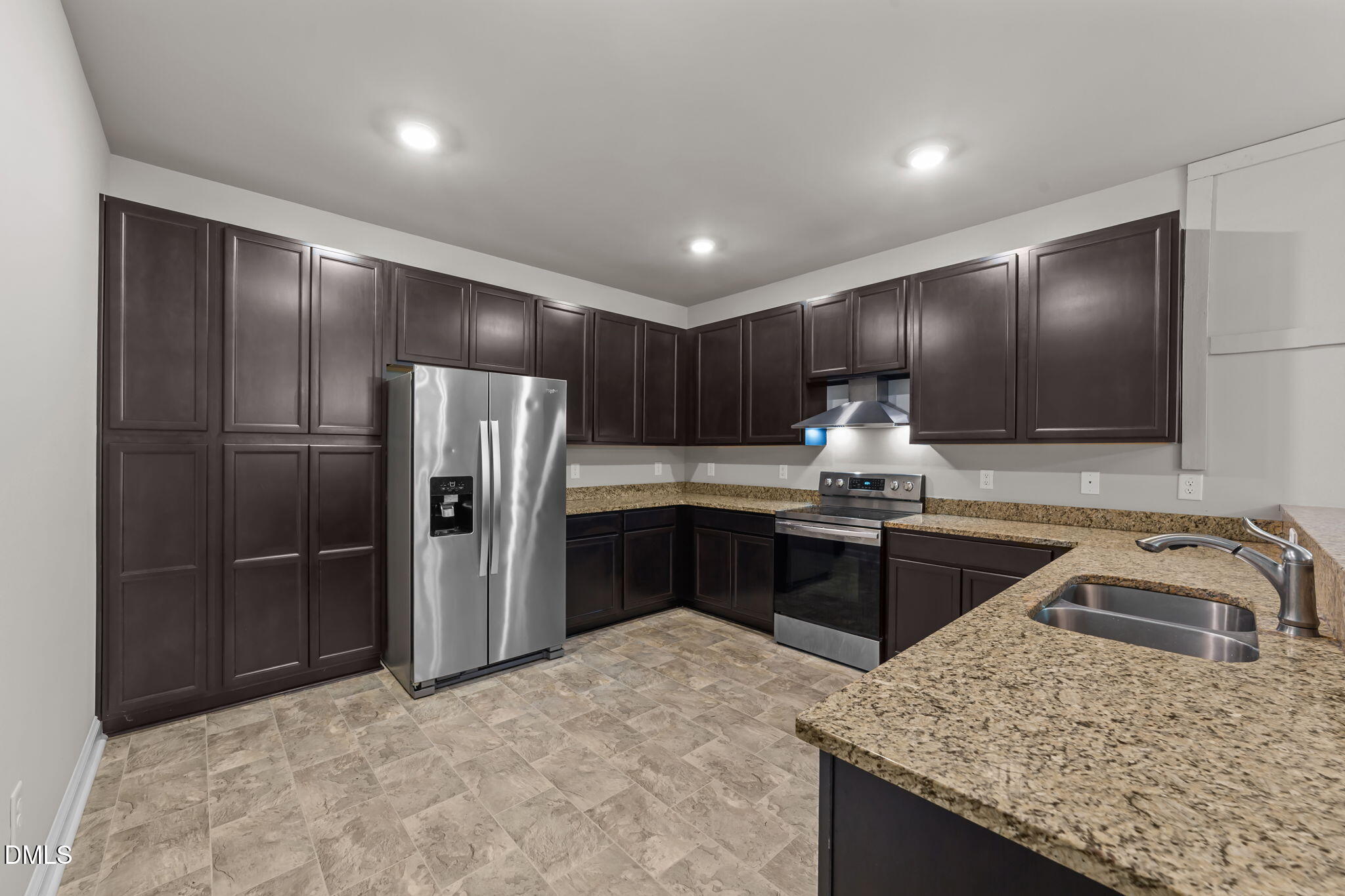 2504 Fleming Road Fuquay-Varina, NC 27526 - Photo 11 of 41 a kitchen with granite countertop a refrigerator and a sink