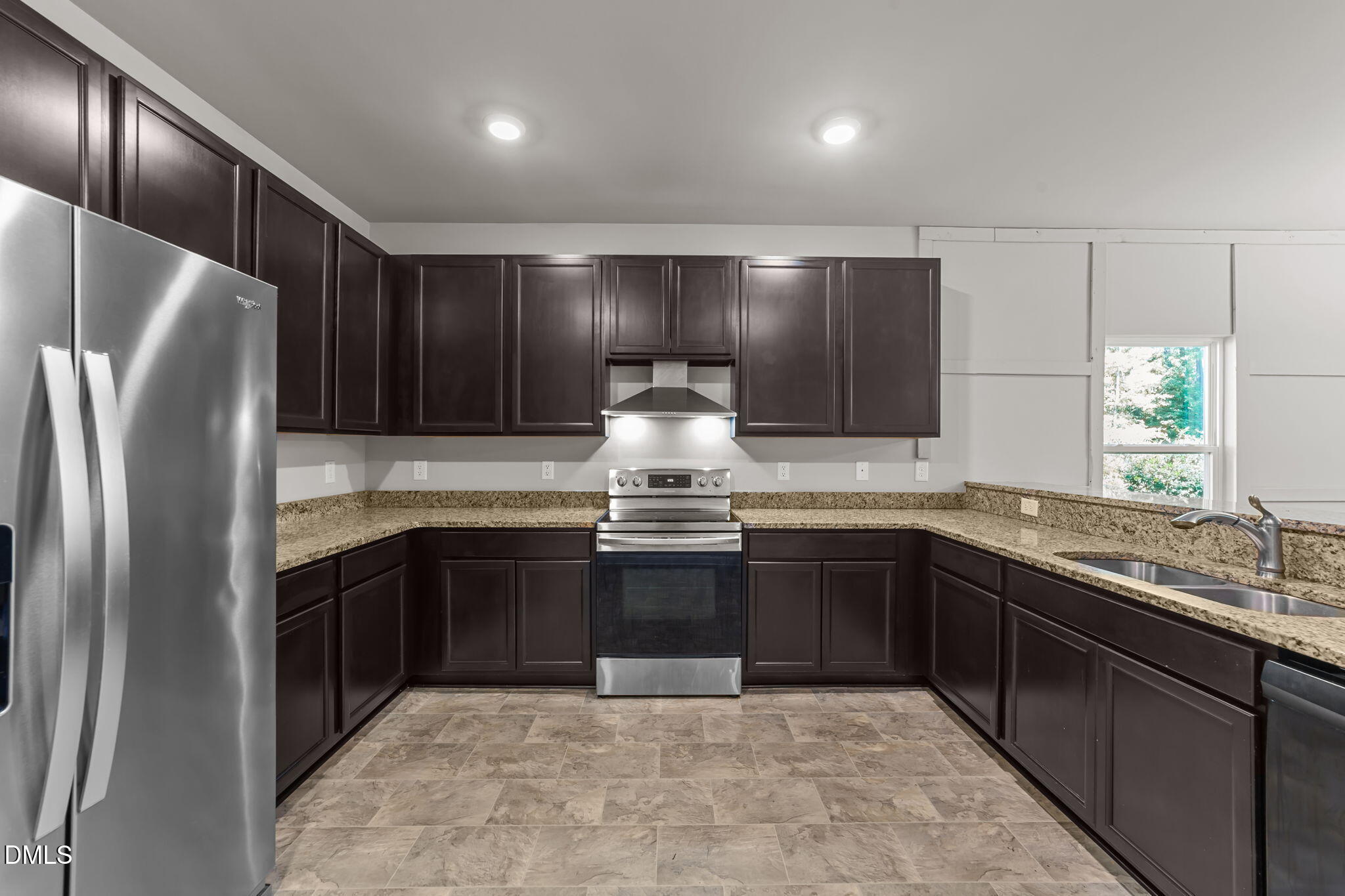 2504 Fleming Road Fuquay-Varina, NC 27526 - Photo 13 of 41 a kitchen with stainless steel appliances granite countertop a sink stove and refrigerator
