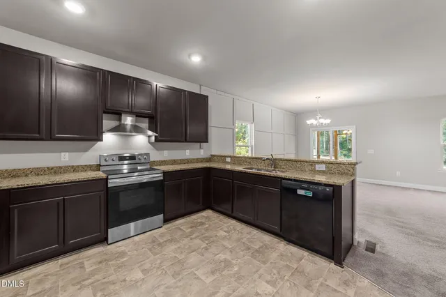 a kitchen with granite countertop stainless steel appliances and wooden cabinets