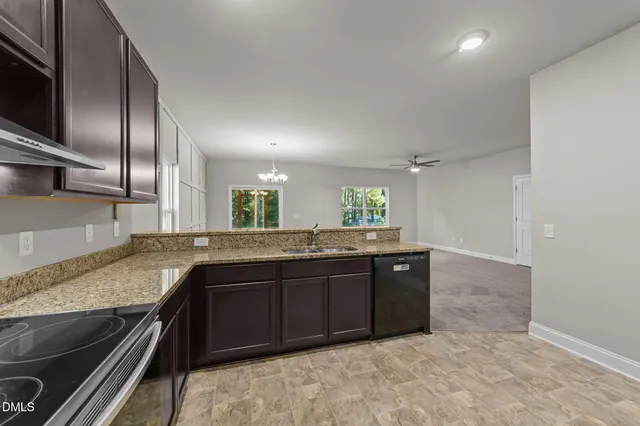 a bathroom with a granite countertop double vanity and a sink