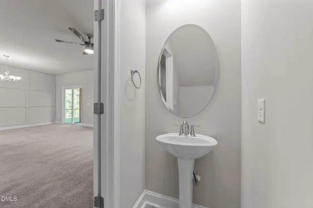 a bathroom with a sink a mirror and a window