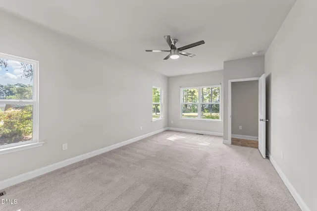 a view of room with a ceiling fan and window