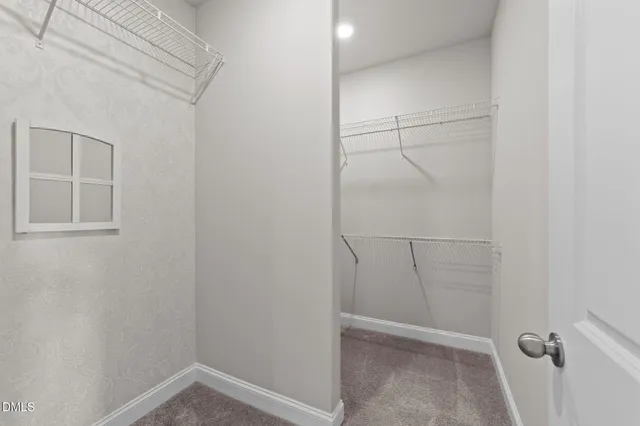 a bathroom with a granite countertop double vanity and a mirror
