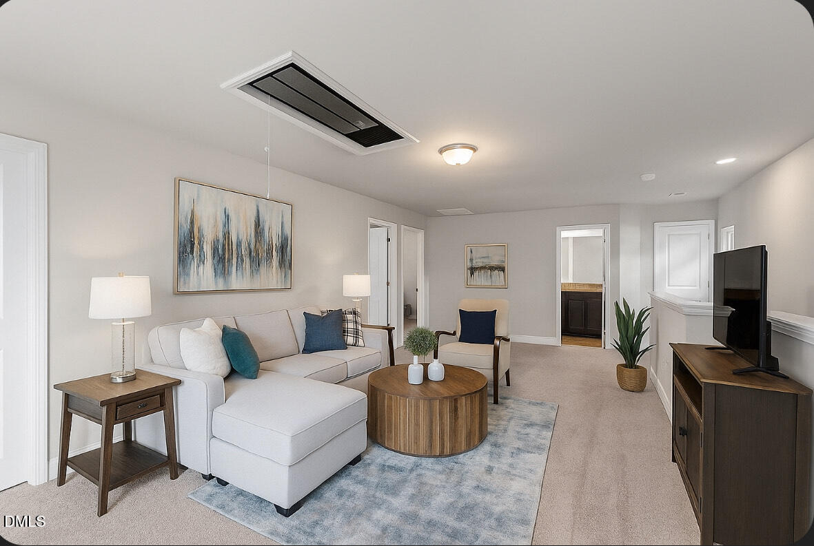 2504 Fleming Road Fuquay-Varina, NC 27526 - Photo 31 of 41 a living room with furniture a flat screen tv and a lamp