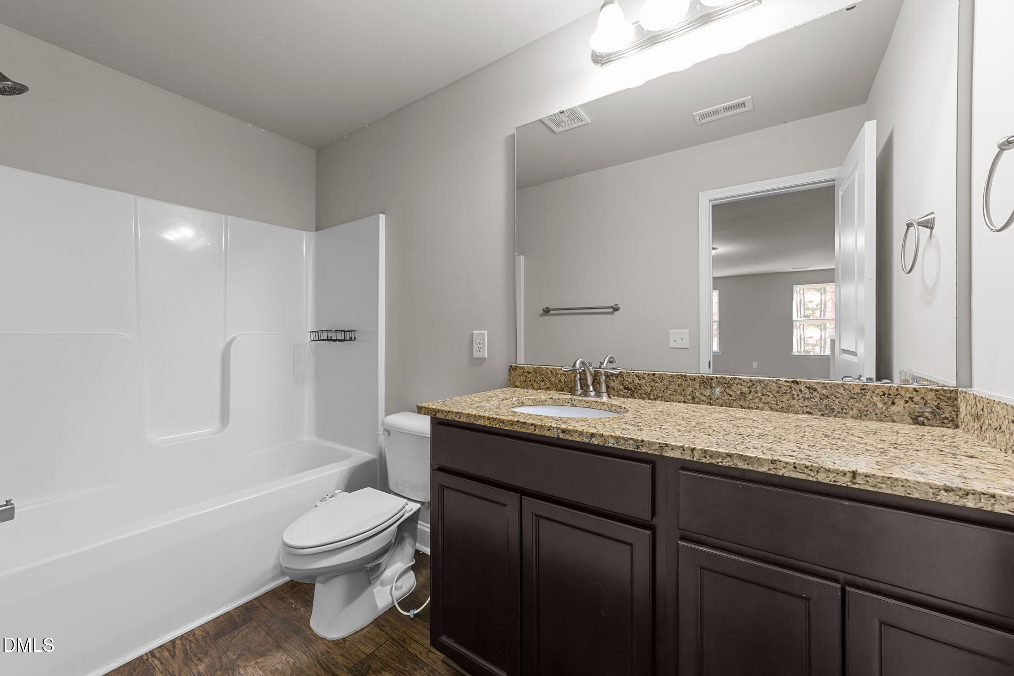 2504 Fleming Road Fuquay-Varina, NC 27526 - Photo 34 of 41 a bathroom with a granite countertop toilet sink and mirror