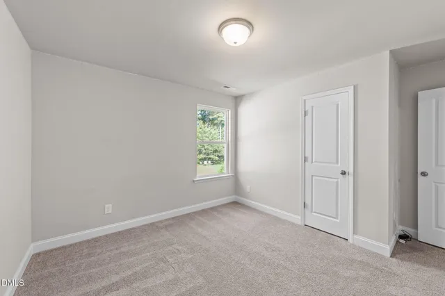 an empty room with closet area