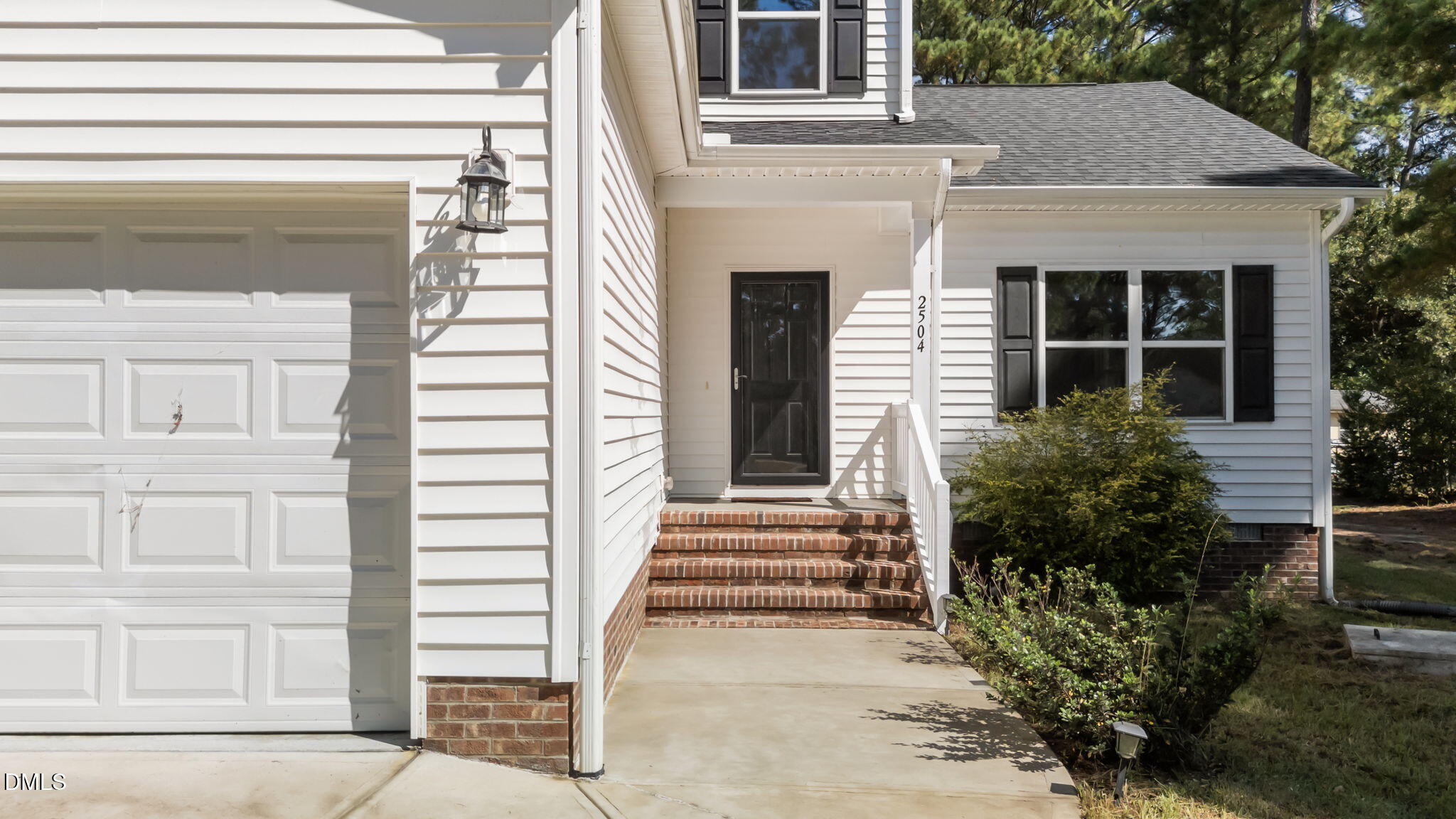 2504 Fleming Road Fuquay-Varina, NC 27526 - Photo 5 of 41 a front view of a house with a garden
