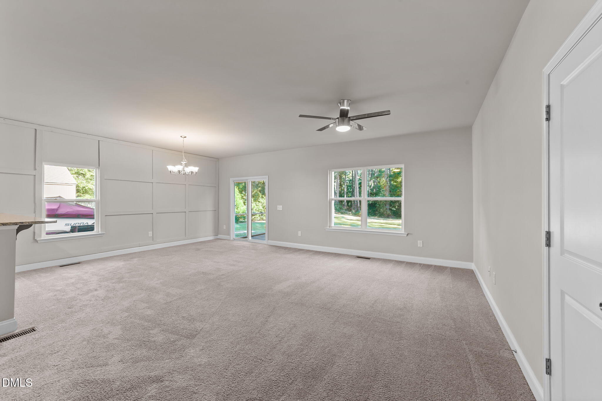 2504 Fleming Road Fuquay-Varina, NC 27526 - Photo 7 of 41 a view of a room with window and chandelier fan
