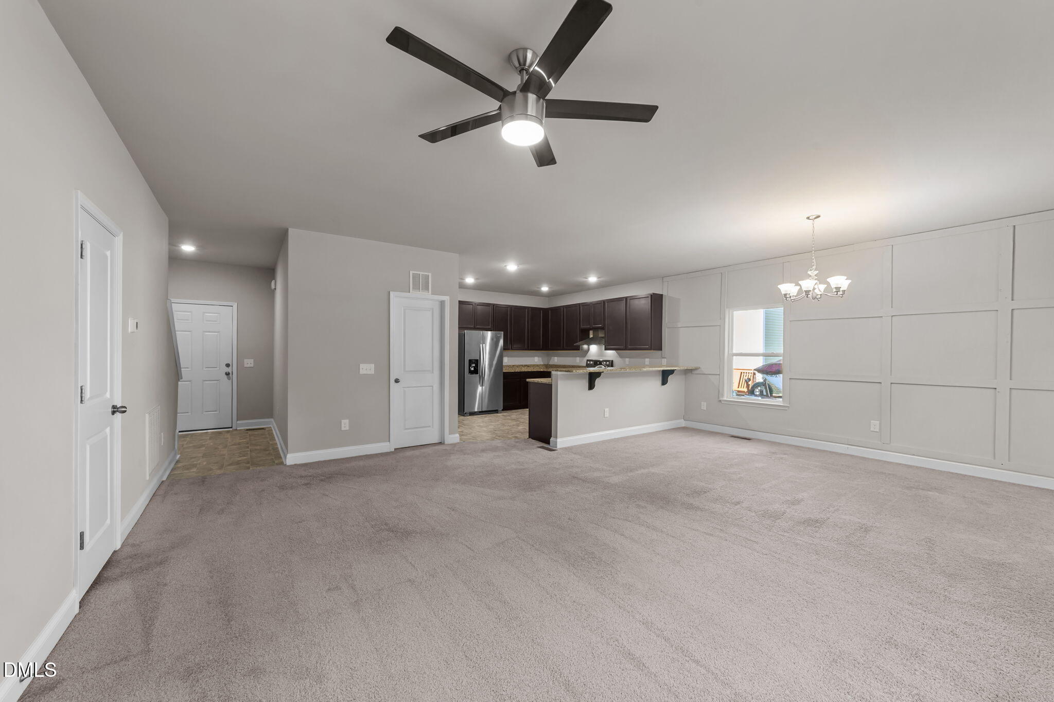 2504 Fleming Road Fuquay-Varina, NC 27526 - Photo 8 of 41 a view of a livingroom with a ceiling fan and kitchen view
