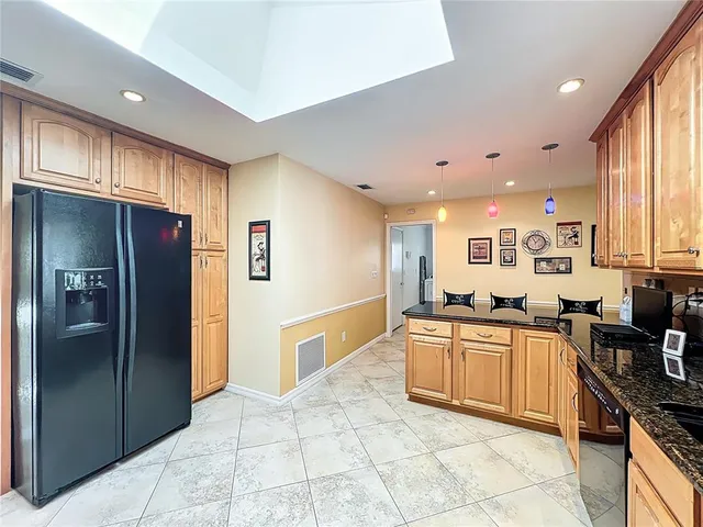 a large kitchen with stainless steel appliances lots of counter top space