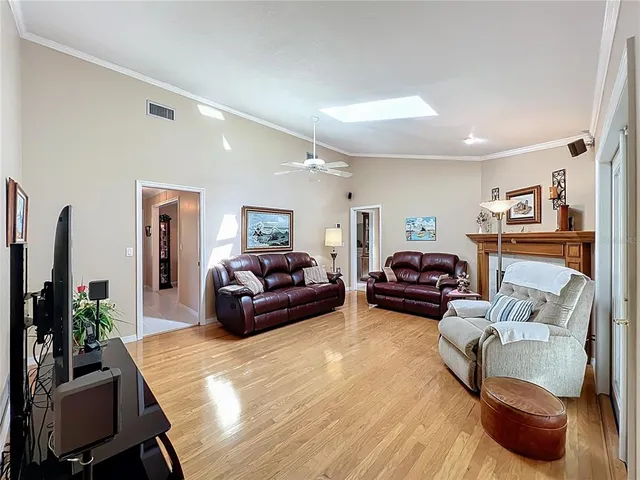 a spacious bedroom with a bed a couch and a chandelier