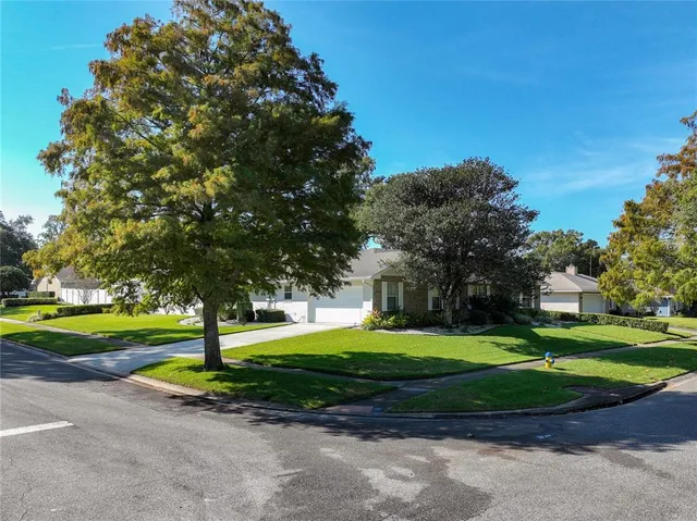 an aerial view of a houses with a yard