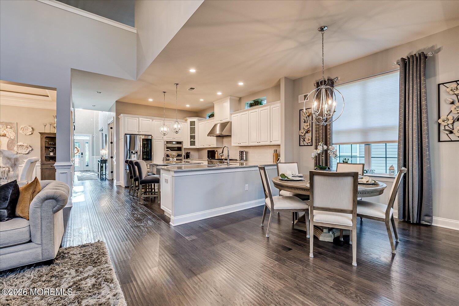 9 Militia Hill Road Freehold, NJ 07728 - Photo 16 of 67 a view of a dining room and livingroom with furniture wooden floor a chandelier