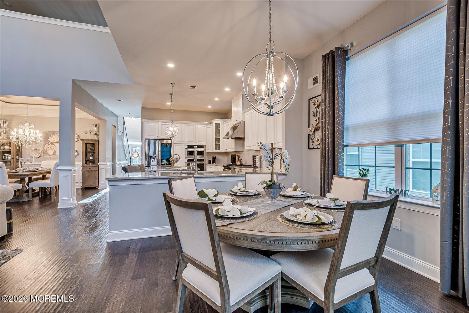 9 Militia Hill Road Freehold, NJ 07728 - Photo 17 of 67 a dining room with wooden floor a chandelier a wooden table and chairs
