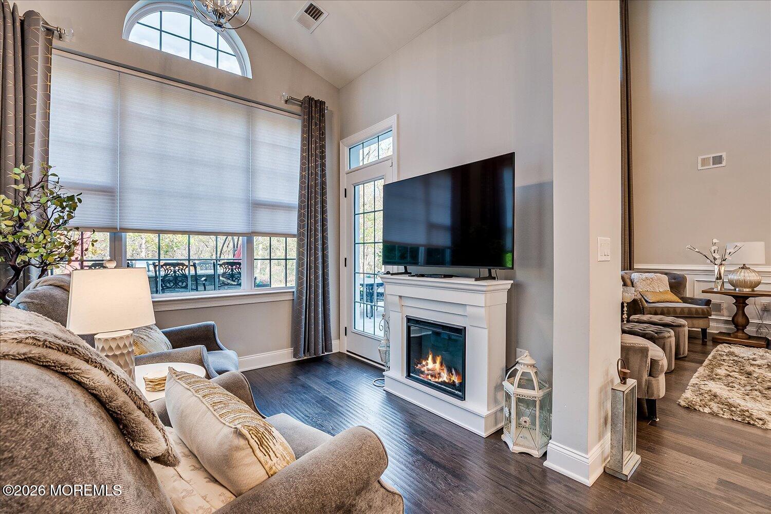 9 Militia Hill Road Freehold, NJ 07728 - Photo 18 of 67 a living room with furniture a flat screen tv and a fireplace