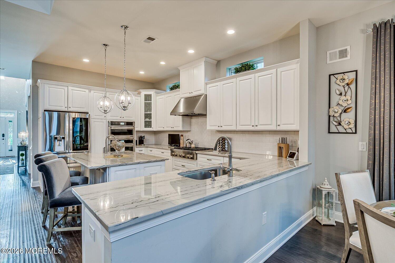 9 Militia Hill Road Freehold, NJ 07728 - Photo 19 of 67 a kitchen with stainless steel appliances granite countertop a sink refrigerator and cabinets