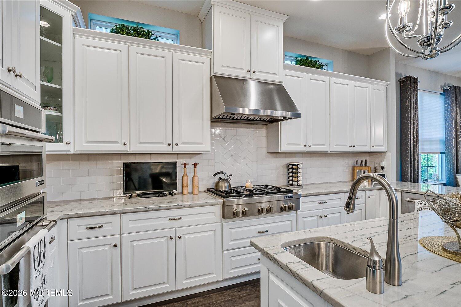 9 Militia Hill Road Freehold, NJ 07728 - Photo 24 of 67 a kitchen with white cabinets and a sink