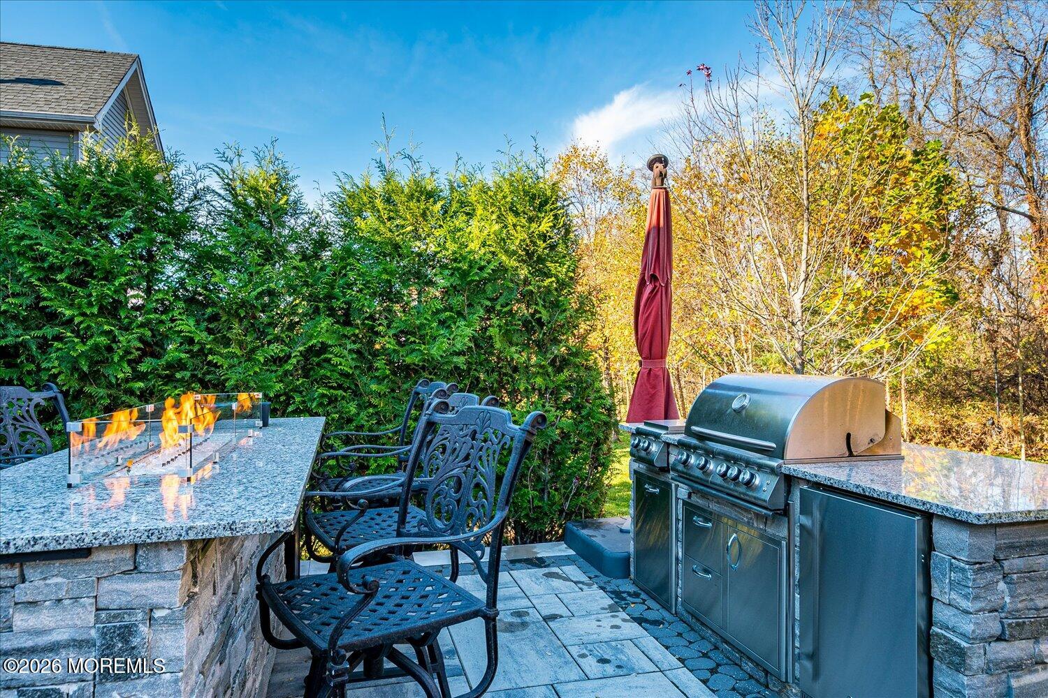 9 Militia Hill Road Freehold, NJ 07728 - Photo 50 of 67 a backyard of a house with table and chairs