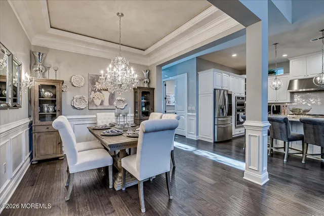 a living room with lots of furniture and view of kitchen