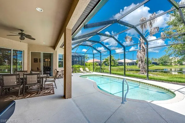 a swimming pool with outdoor seating and yard