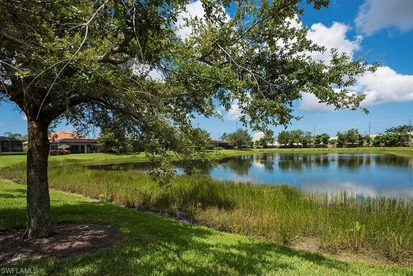 a view of a lake with a house in the background