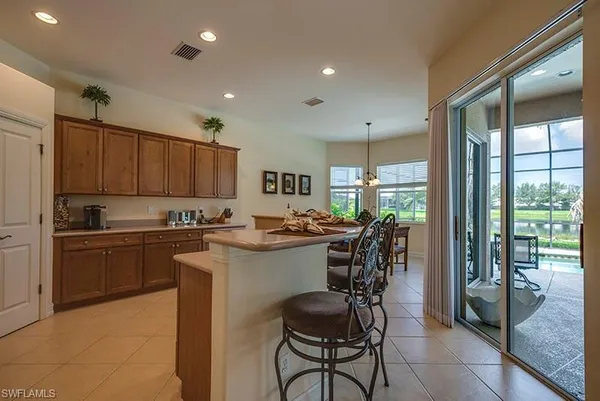 a kitchen with a table chairs stove and cabinets