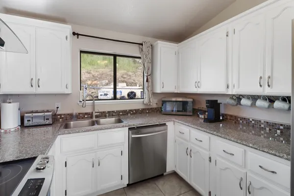 a kitchen with a stove and cabinets