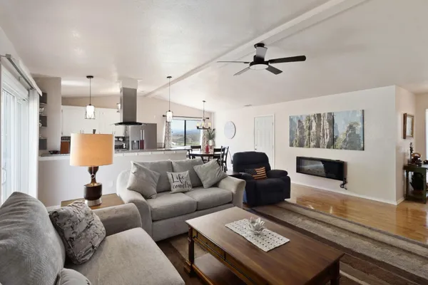 a bedroom with a bed and painting on the wall