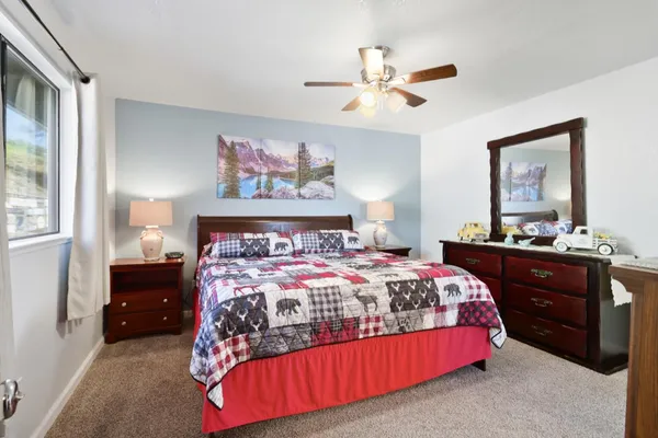 a bedroom with a bed and flat screen tv