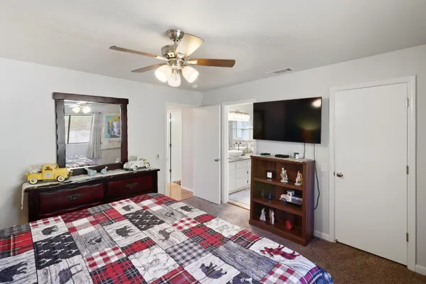 a bedroom with a bed and a flat screen tv