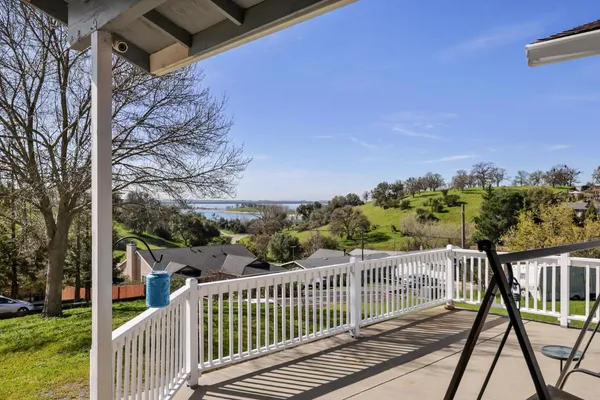 a view of a balcony with wooden fence and floor