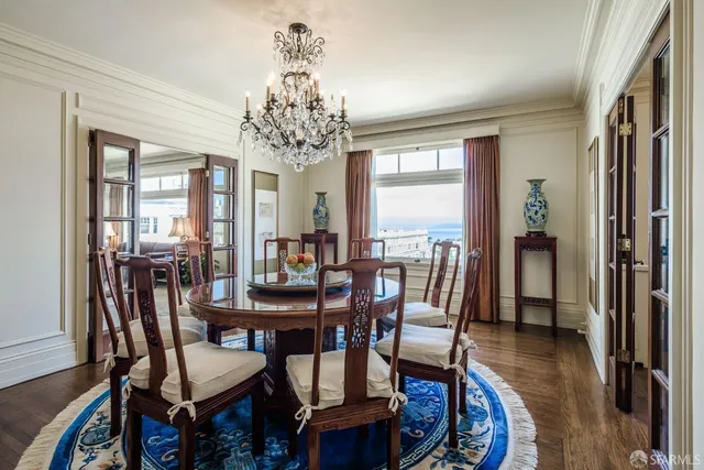 a view of a dining room with furniture wooden floor and chandelier