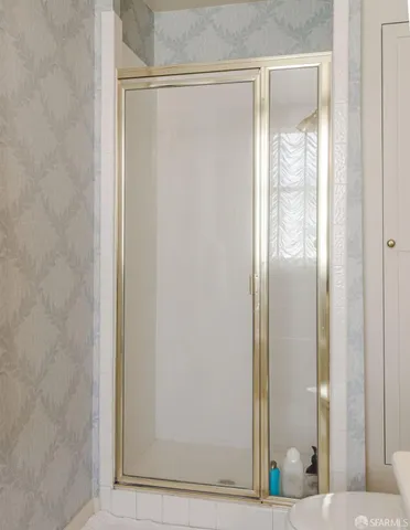 a bedroom with a bed lamp and a potted plant