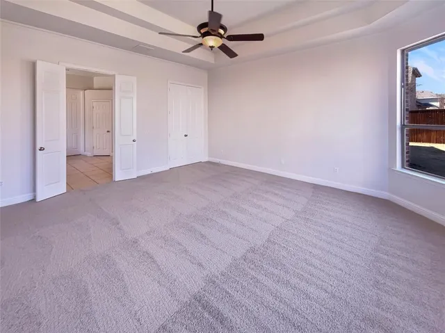 a spacious bathroom with a mirror a sink and a shower