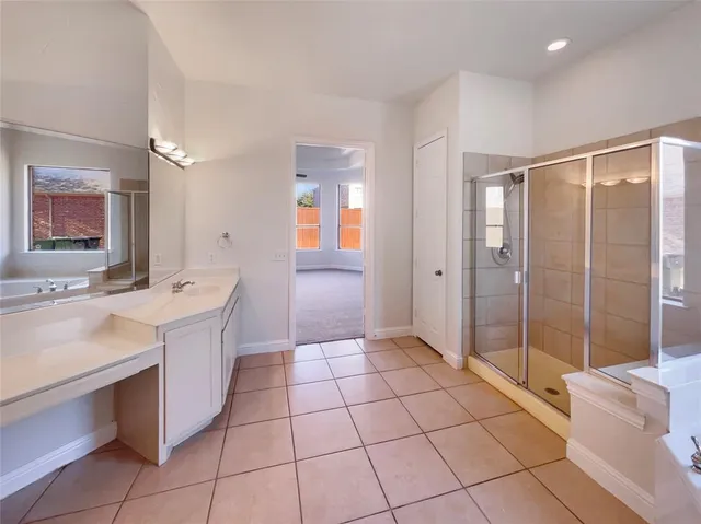 an empty room with windows and fireplace