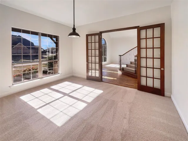 a view of a big room with closet and windows in it