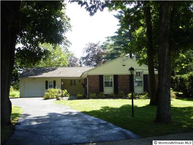11 Peach Tree Road Oakhurst, NJ 07755 - Photo 1 of 3 a front view of a house with a yard