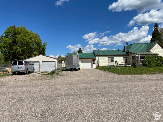 114 West 4th Street Georgetown, ID 83239 - Photo 1 of 1 View of front facade with a garage, metal roof, and an outbuilding