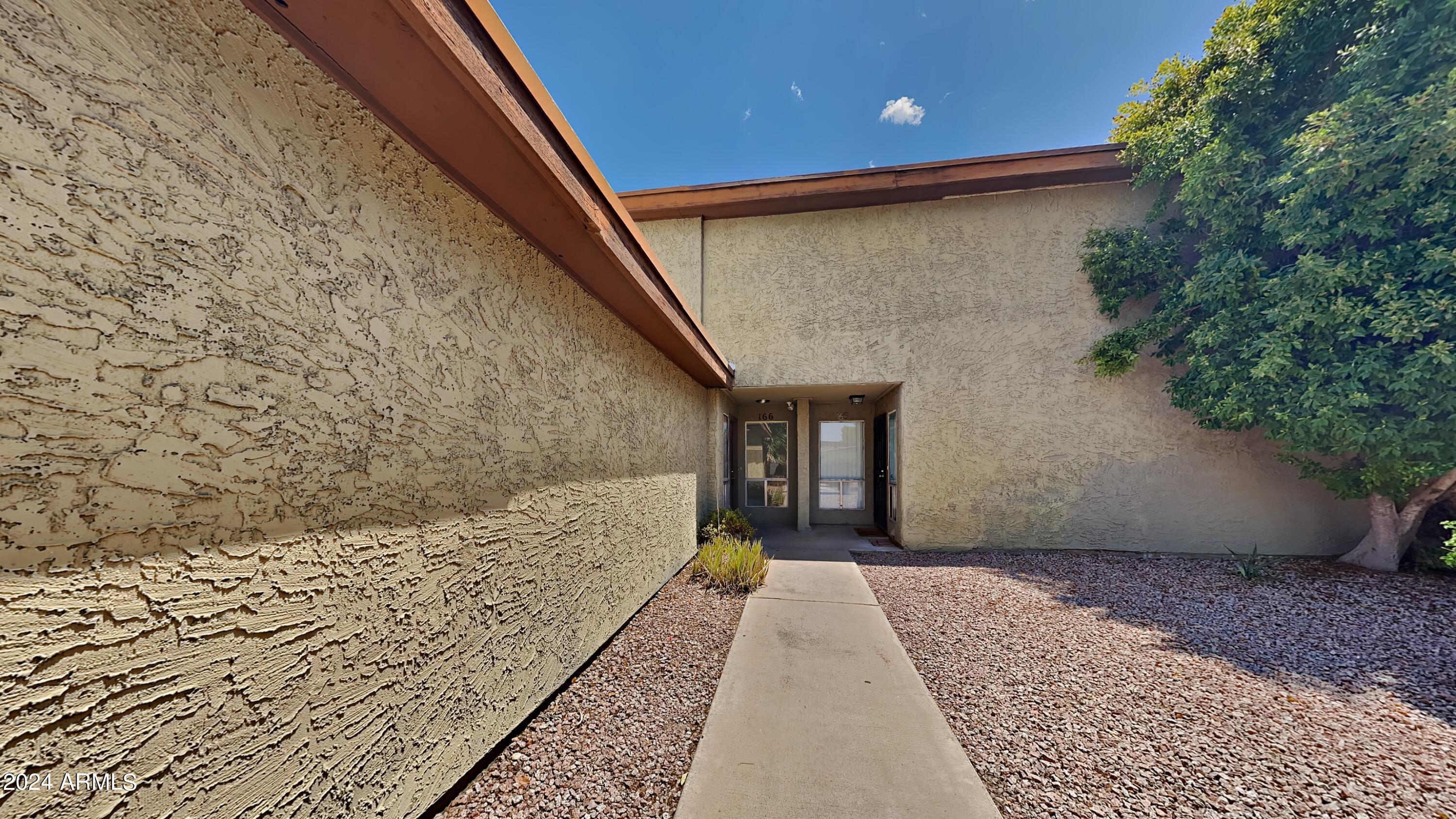 1051 South Dobson Road, Unit 166 Mesa, AZ 85202 - Photo 5 of 13 a front view of a house with a yard