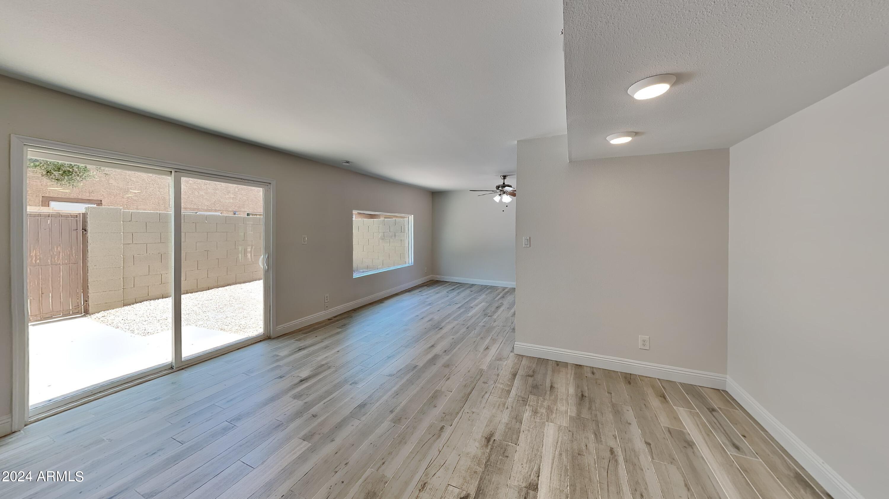 1051 South Dobson Road, Unit 166 Mesa, AZ 85202 - Photo 7 of 13 wooden floor in an empty room with a window