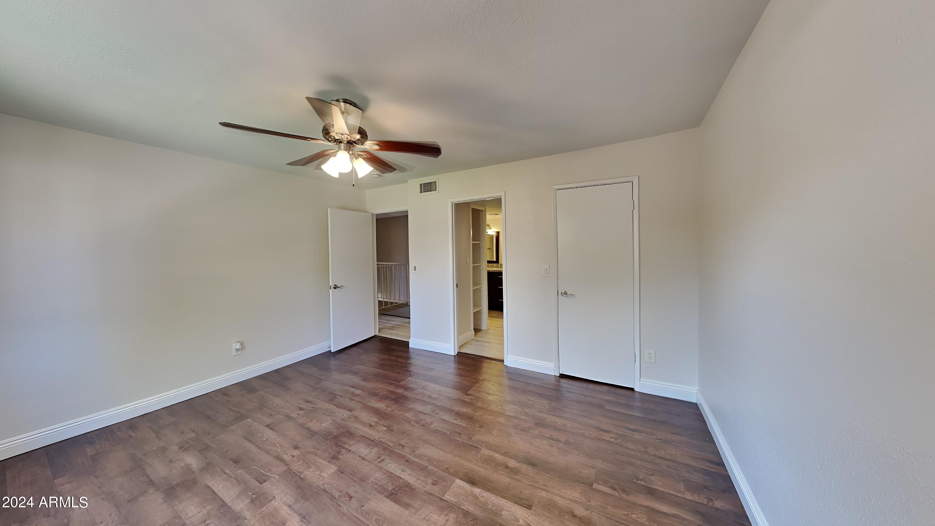 1051 South Dobson Road, Unit 166 Mesa, AZ 85202 - Photo 10 of 13 a view of an empty room with wooden floor