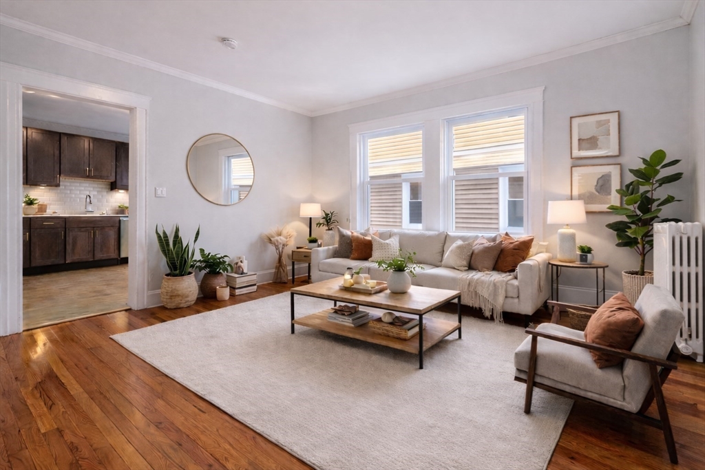193 Florence Street, Unit 2R Boston, MA 02131 - Photo 3 of 14 a living room with furniture fireplace and a large window