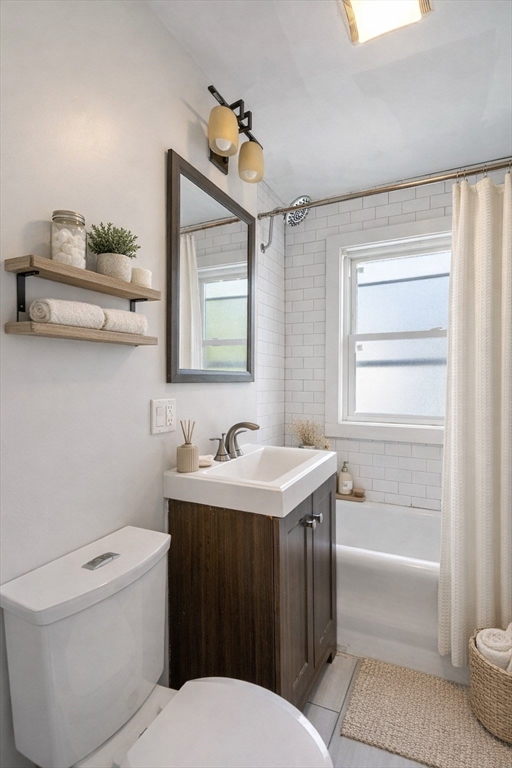 193 Florence Street, Unit 2R Boston, MA 02131 - Photo 5 of 14 a bathroom with a sink a toilet and shower