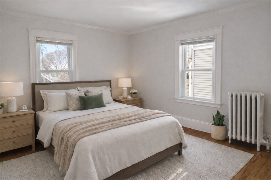 193 Florence Street, Unit 2R Boston, MA 02131 - Photo 6 of 14 a bedroom with a bed and a window