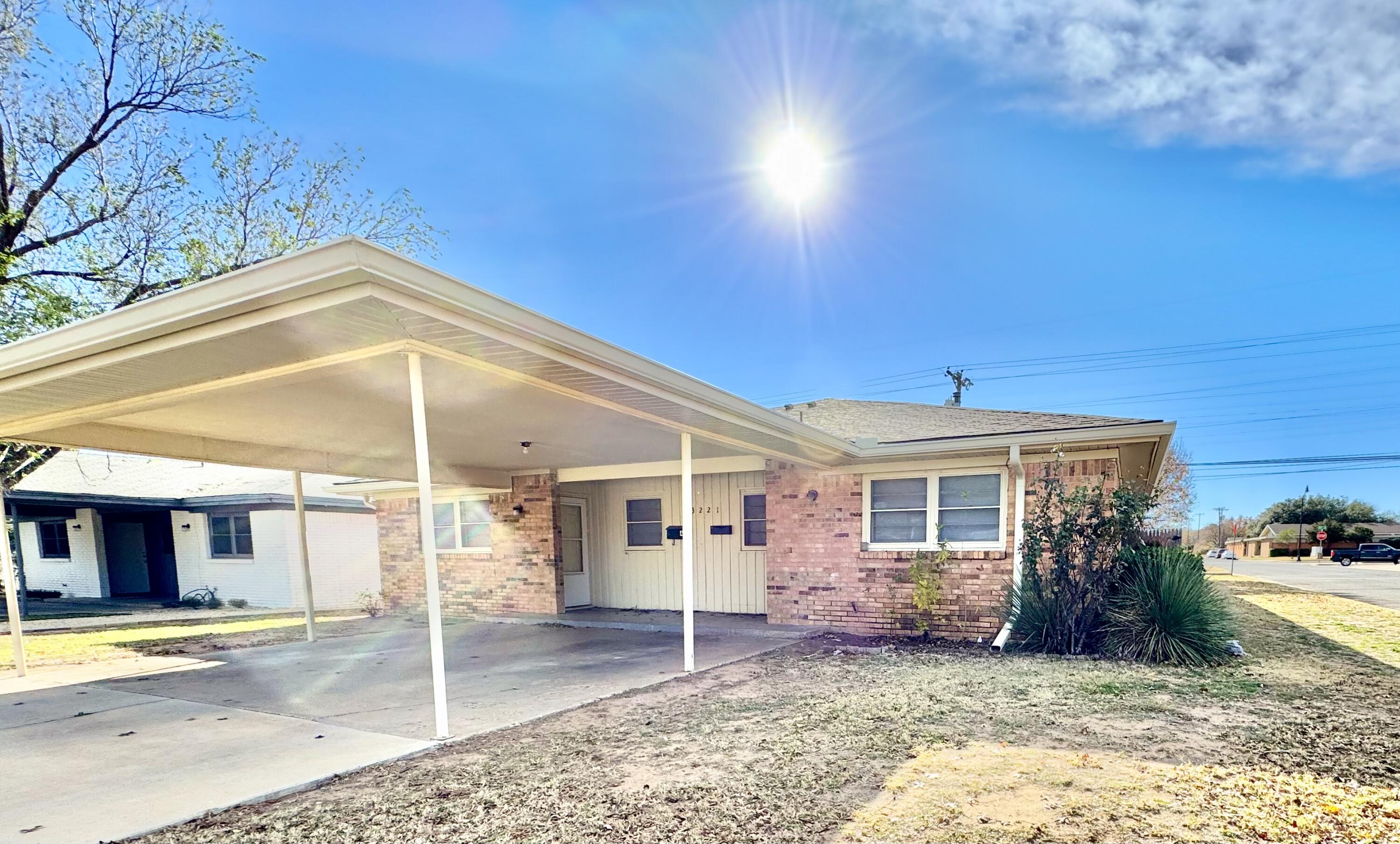 3221 33rd Street, Unit B Lubbock, TX 79410 - Photo 1 of 2 a view of a house with a patio and a yard