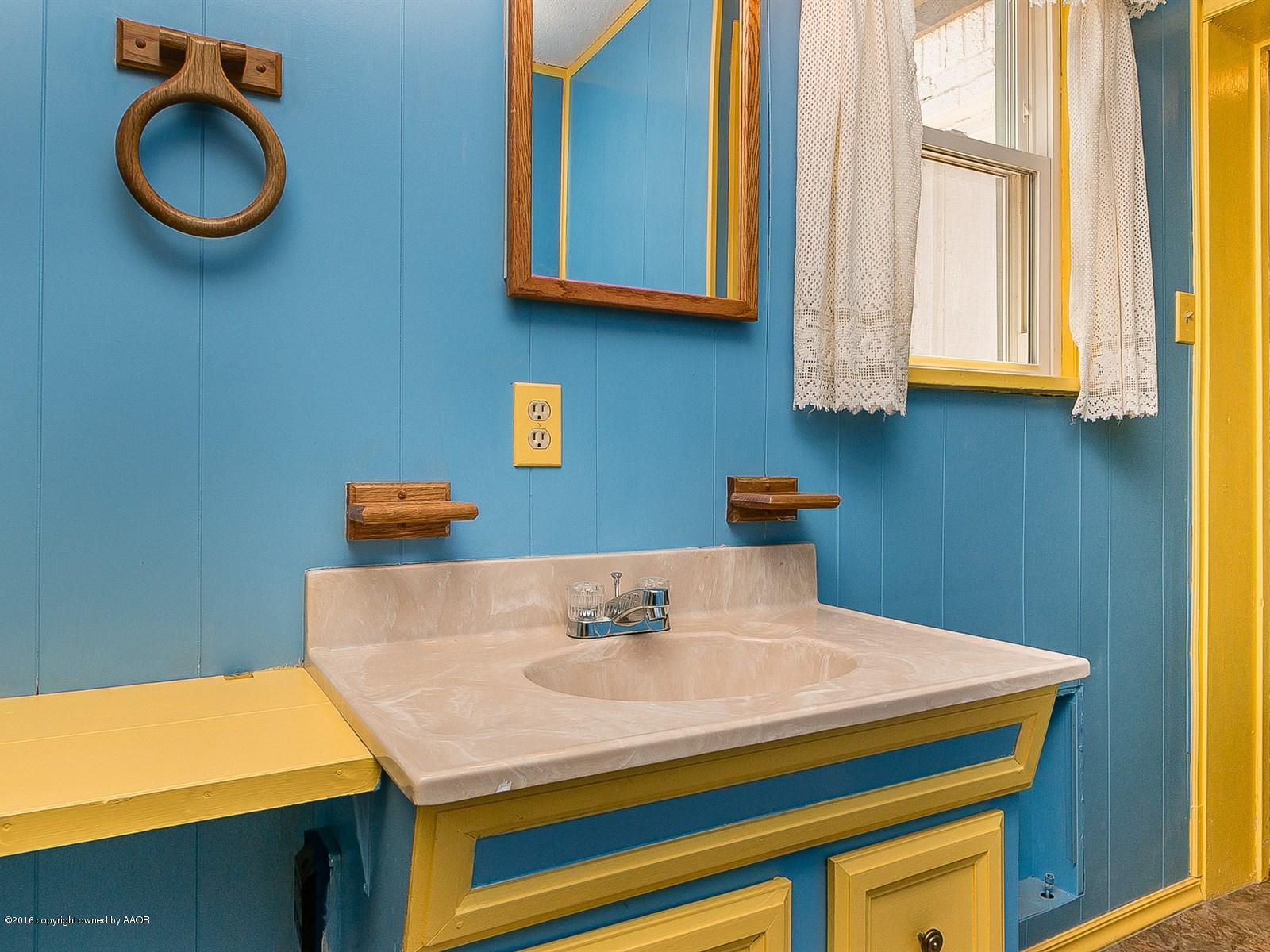 1227 South Bonham Street Amarillo, TX 79102 - Photo 15 of 25 a bathroom with a sink and a mirror