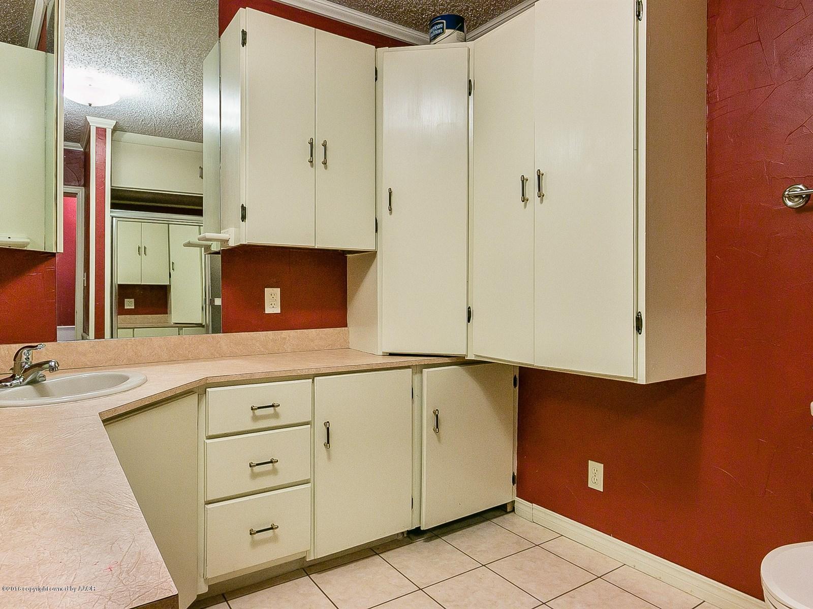 1227 South Bonham Street Amarillo, TX 79102 - Photo 18 of 25 a view of a kitchen with cabinets and a wooden floor