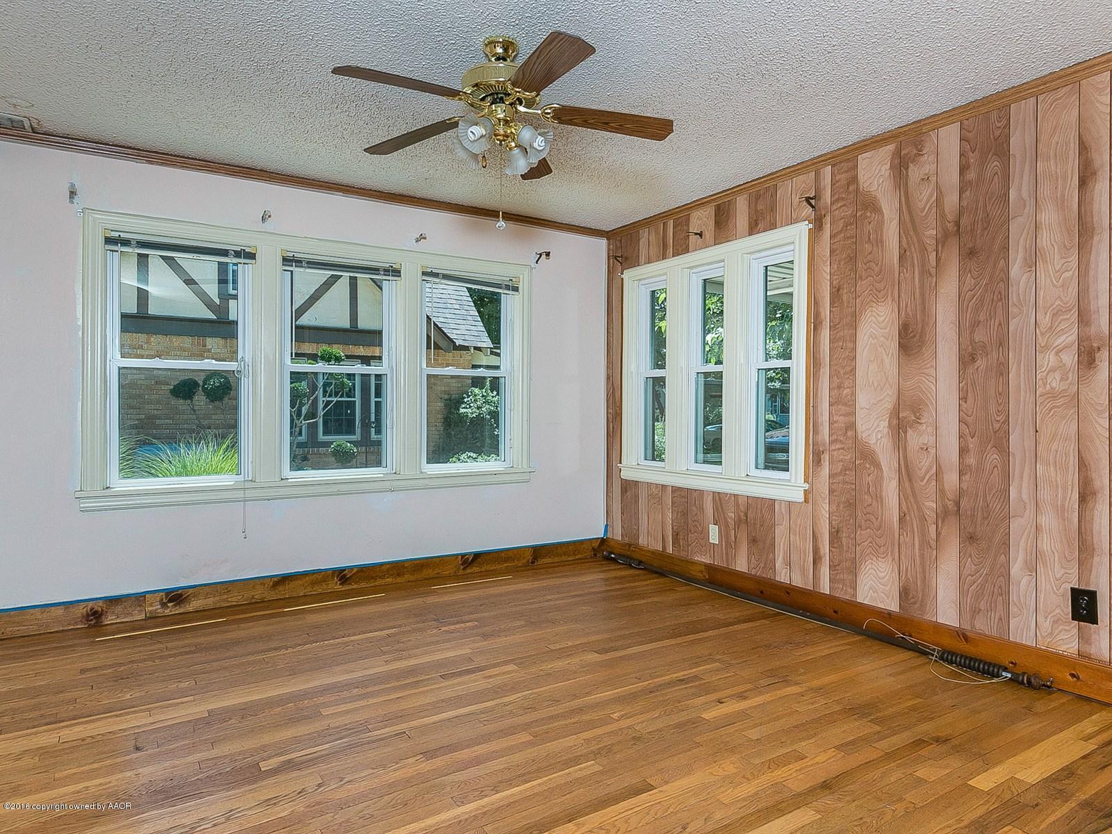 1227 South Bonham Street Amarillo, TX 79102 - Photo 6 of 25 a view of an empty room with a window and wooden floor